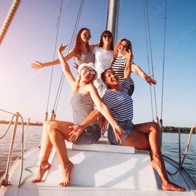 a woman riding on the back of a boat